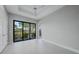 This bedroom features tile flooring, sliding glass doors, and a ceiling fan at 183 Maria Ct, Punta Gorda, FL 33950