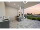 Modern outdoor kitchen with stainless steel grill and sink overlooking the water at 183 Maria Ct, Punta Gorda, FL 33950