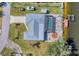 Birds eye view of a waterfront home with pool, boat dock, manicured lawn, and lush landscaping at 18390 Burkholder Cir, Port Charlotte, FL 33948