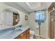 Bathroom showing a glass shower door, geometric floor, and round mirror at 18390 Burkholder Cir, Port Charlotte, FL 33948