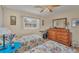 Cozy bedroom featuring laminate floors, two twin beds and a sunny window at 18390 Burkholder Cir, Port Charlotte, FL 33948