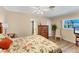 Cozy bedroom with wood-look floors, neutral walls, and plenty of space at 18390 Burkholder Cir, Port Charlotte, FL 33948