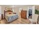 Cozy bedroom features a ceiling fan, wood floors, and a closet at 18390 Burkholder Cir, Port Charlotte, FL 33948