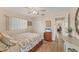 Comfortable bedroom with laminate flooring, closet, and a ceiling fan at 18390 Burkholder Cir, Port Charlotte, FL 33948