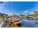 Inviting waterfront view with a private dock for boating and relaxation under a clear blue sky at 18390 Burkholder Cir, Port Charlotte, FL 33948