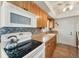 Kitchen features natural wood cabinets, stone backsplash, and white appliances at 18390 Burkholder Cir, Port Charlotte, FL 33948