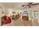 Cozy living room features tile flooring, ceiling fan, and bright decor at 18390 Burkholder Cir, Port Charlotte, FL 33948