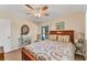 Relaxing main bedroom with laminate floors, ceiling fan, and access to pool at 18390 Burkholder Cir, Port Charlotte, FL 33948