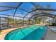 Beautiful screened-in pool with a covered patio and scenic views of the canal at 18390 Burkholder Cir, Port Charlotte, FL 33948