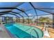 A beautiful screened in pool with a view of the water at 18390 Burkholder Cir, Port Charlotte, FL 33948