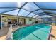 Inviting screened-in pool area featuring a sparkling pool and covered patio space for outdoor enjoyment at 18390 Burkholder Cir, Port Charlotte, FL 33948