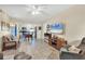 Living room with open concept kitchen, tiled floor and ceiling fan at 19505 Quesada Ave # Jj101, Port Charlotte, FL 33948