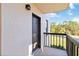 Cozy balcony with black railings beside a door leading to the condo unit and a view of the outdoors at 1999 Kings Hwy # 16B, Punta Gorda, FL 33980