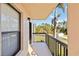 Balcony with black railings overlooking the landscape with a small tree and green space at 1999 Kings Hwy # 16B, Punta Gorda, FL 33980