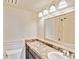 Well-lit bathroom featuring a vanity with a granite countertop, a mirror, and a shower at 1999 Kings Hwy # 16B, Punta Gorda, FL 33980