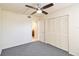 Bright bedroom featuring a ceiling fan, large closet, and doorway to an ensuite bathroom at 1999 Kings Hwy # 16B, Punta Gorda, FL 33980