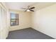 A carpeted bedroom features a ceiling fan, a large closet and plenty of natural light at 1999 Kings Hwy # 16B, Punta Gorda, FL 33980