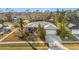 Single-story house with a gray roof, white garage door, and surrounding neighborhood visible at 2202 Gold Oak Ln, Sarasota, FL 34232