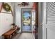 Inviting entryway with wood bench and view of backyard at 2202 Gold Oak Ln, Sarasota, FL 34232