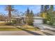 Single-story home with a gray exterior, white garage door, and well-manicured landscaping at 2202 Gold Oak Ln, Sarasota, FL 34232