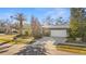 Single-story home with a gray exterior, white garage door, and driveway at 2202 Gold Oak Ln, Sarasota, FL 34232