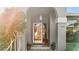 Home entrance with arched entryway, glass door, and potted plants at 2202 Gold Oak Ln, Sarasota, FL 34232