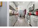 Modern kitchen with gray cabinets and stainless steel appliances at 2202 Gold Oak Ln, Sarasota, FL 34232