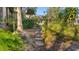 Stone pathway through a lush, landscaped side yard at 2202 Gold Oak Ln, Sarasota, FL 34232