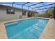 Refreshing swimming pool surrounded by a spacious screened patio at 2202 Gold Oak Ln, Sarasota, FL 34232