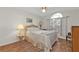 Cozy bedroom with wood flooring and an arched window at 24117 Buckingham Way, Punta Gorda, FL 33980