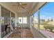 Relaxing screened porch with tiled floor, seating area, and view of backyard at 24117 Buckingham Way, Punta Gorda, FL 33980