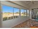 Bright screened porch with tiled floor and sliding glass doors offering a scenic view at 24117 Buckingham Way, Punta Gorda, FL 33980