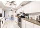 Galley-style kitchen with black appliances and granite countertops at 2455 Pellam Blvd, Port Charlotte, FL 33948