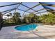 Inviting kidney-shaped pool with screened enclosure at 2455 Pellam Blvd, Port Charlotte, FL 33948