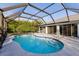 Refreshing kidney-shaped pool, screened patio and house view at 2455 Pellam Blvd, Port Charlotte, FL 33948