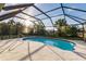 Relaxing kidney-shaped pool with screened enclosure at 2455 Pellam Blvd, Port Charlotte, FL 33948