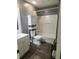 Bathroom with tub, toilet, vanity, and wood-look flooring at 2461 Ivanhoe St, Port Charlotte, FL 33952