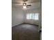 Bright bedroom with carpeted floor, ceiling fan, and window coverings at 2461 Ivanhoe St, Port Charlotte, FL 33952