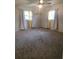 Main bedroom with neutral carpeting, ceiling fan, and ample natural light at 2461 Ivanhoe St, Port Charlotte, FL 33952