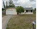 Ranch style home with a single car garage and well-maintained lawn at 2461 Ivanhoe St, Port Charlotte, FL 33952