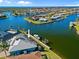 Aerial of waterfront home with private dock and boat lift, nestled in a coastal community with gulf access at 2580 Brazilia Ct, Punta Gorda, FL 33950