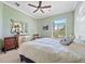 Comfortable bedroom features a ceiling fan, dresser and accent mirror at 2580 Brazilia Ct, Punta Gorda, FL 33950