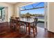 Elegant dining room features a large window overlooking the water and a wooden table with seating for six at 2580 Brazilia Ct, Punta Gorda, FL 33950