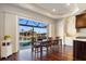 Dining area with wood floors, water views and sliding glass doors to lanai at 2580 Brazilia Ct, Punta Gorda, FL 33950