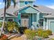 Charming covered front porch featuring rocking chairs and a landscaped front yard at 2580 Brazilia Ct, Punta Gorda, FL 33950