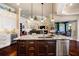 Kitchen island with granite counters, stainless steel sink, and wine cooler with views to the living room at 2580 Brazilia Ct, Punta Gorda, FL 33950