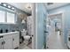 Clean bathroom with nautical-themed shower curtain and white vanity at 2726 N Beach Rd, Englewood, FL 34223