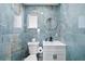 Stylish bathroom with blue marble tile and modern vanity at 2726 N Beach Rd, Englewood, FL 34223