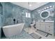 Modern bathroom with blue tile, a large walk-in shower, and a soaking tub at 2726 N Beach Rd, Englewood, FL 34223