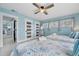 Guest bedroom with twin beds, light blue walls, and access to other rooms at 2726 N Beach Rd, Englewood, FL 34223